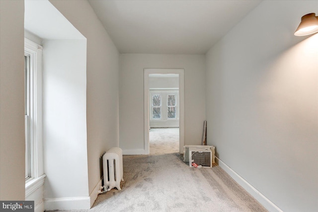 empty room featuring light carpet and radiator