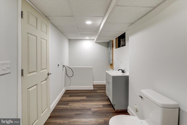 bathroom featuring a paneled ceiling, vanity, toilet, and hardwood / wood-style floors