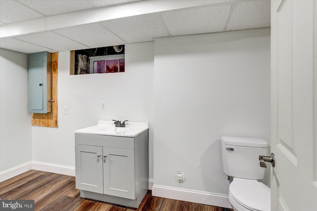 bathroom featuring wood-type flooring, electric panel, and a drop ceiling