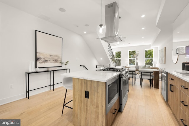 kitchen with island exhaust hood, a breakfast bar, stainless steel appliances, a spacious island, and pendant lighting