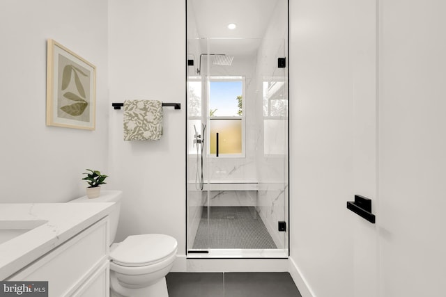 bathroom with tile patterned flooring, a shower with door, vanity, and toilet