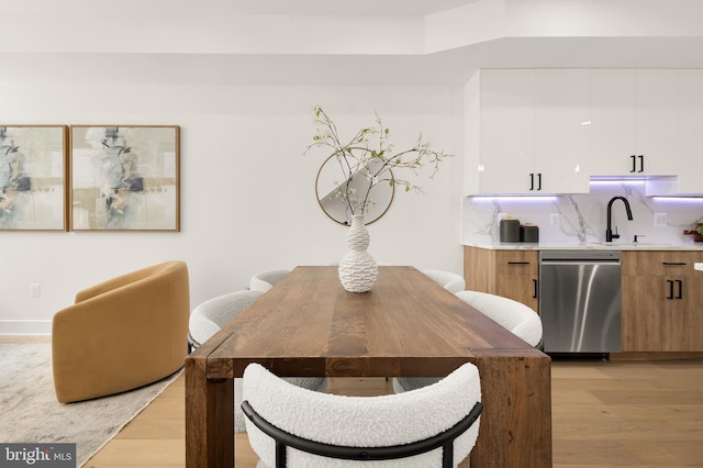 dining space featuring light hardwood / wood-style flooring and sink