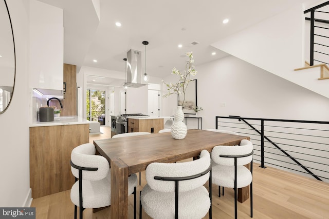 dining room featuring light hardwood / wood-style floors and sink