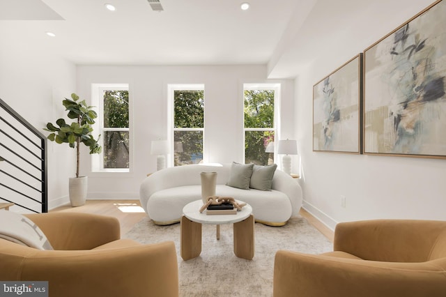 living room with a wealth of natural light and light hardwood / wood-style floors