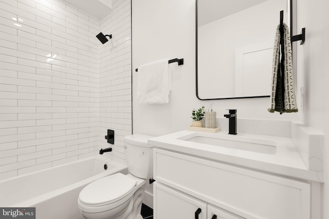 full bathroom with toilet, vanity, and tiled shower / bath