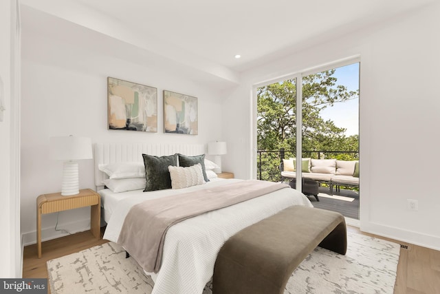 bedroom with access to outside and light hardwood / wood-style floors