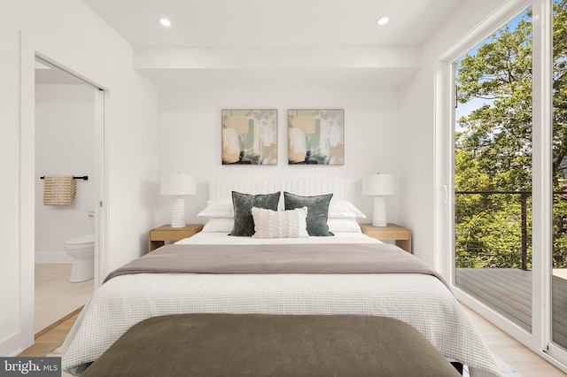 bedroom with access to outside, ensuite bath, and light hardwood / wood-style floors