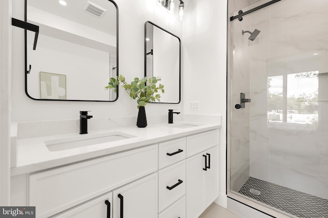 bathroom with vanity and a shower with door