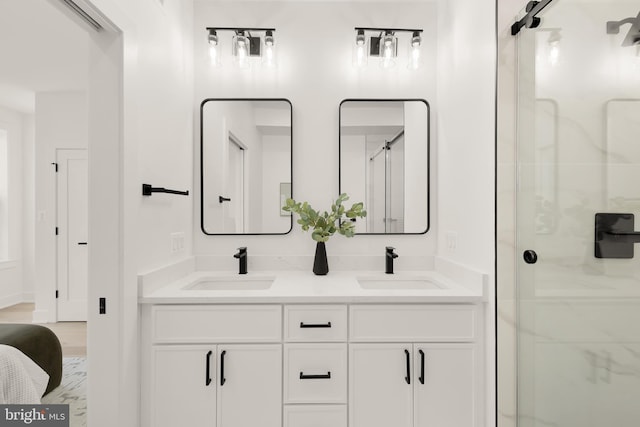 bathroom with vanity and a shower with door