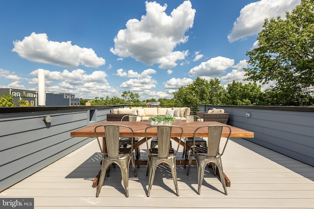 wooden terrace with an outdoor hangout area