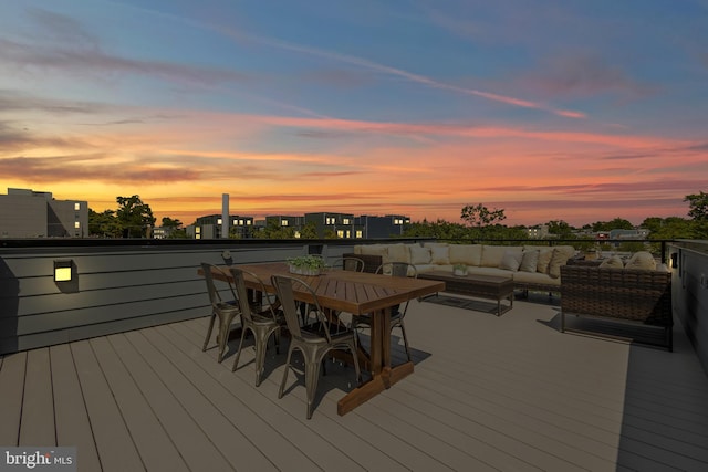 deck at dusk with an outdoor living space