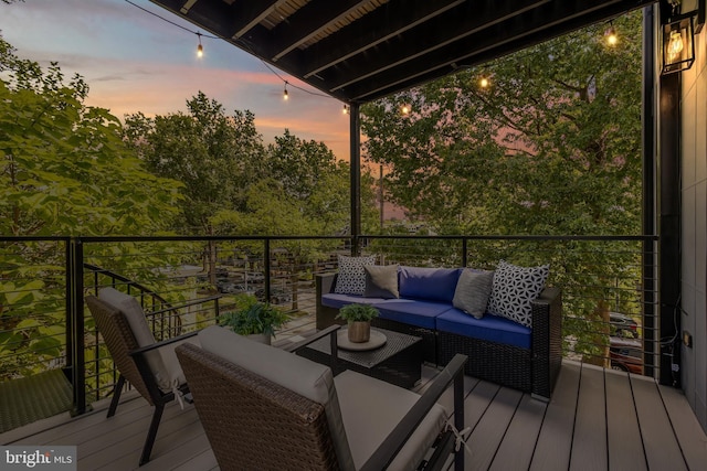 deck at dusk featuring outdoor lounge area