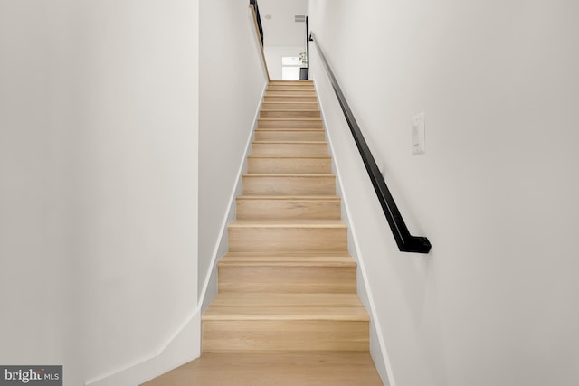 stairway with hardwood / wood-style flooring