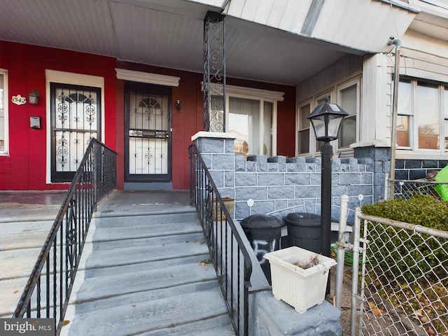 view of exterior entry with a porch