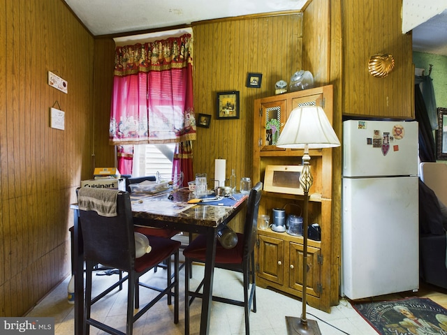 dining area featuring wood walls