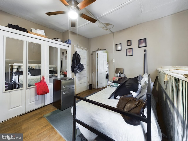 bedroom with ceiling fan and dark hardwood / wood-style floors