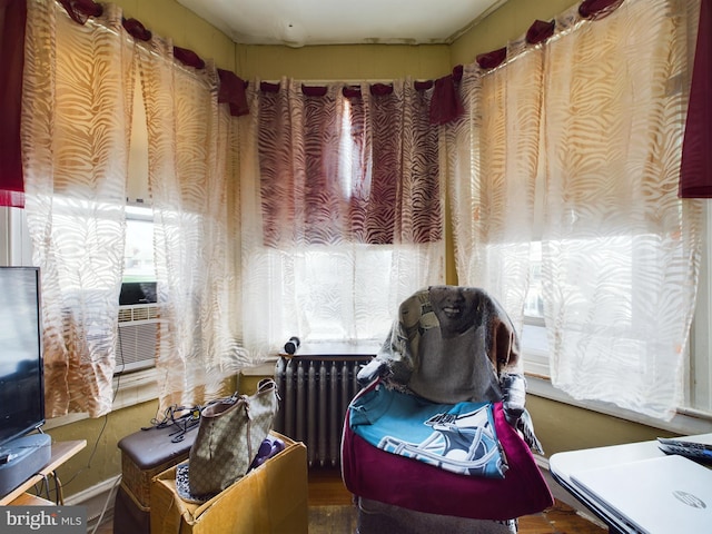 sitting room featuring radiator heating unit and cooling unit