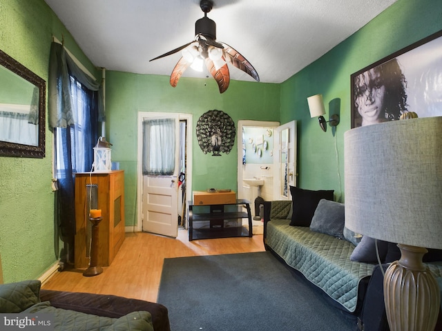 living room with ceiling fan and light wood-type flooring