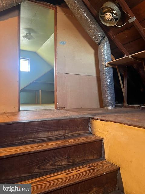 staircase with lofted ceiling