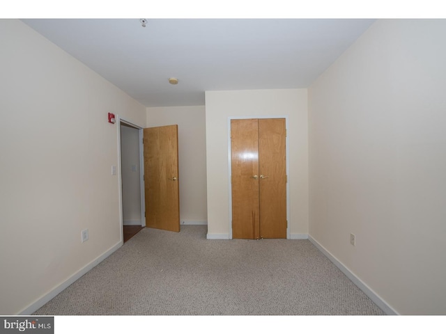 unfurnished bedroom featuring a closet and carpet