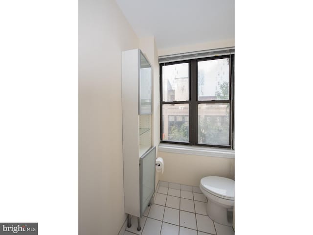 bathroom with tile patterned flooring and toilet