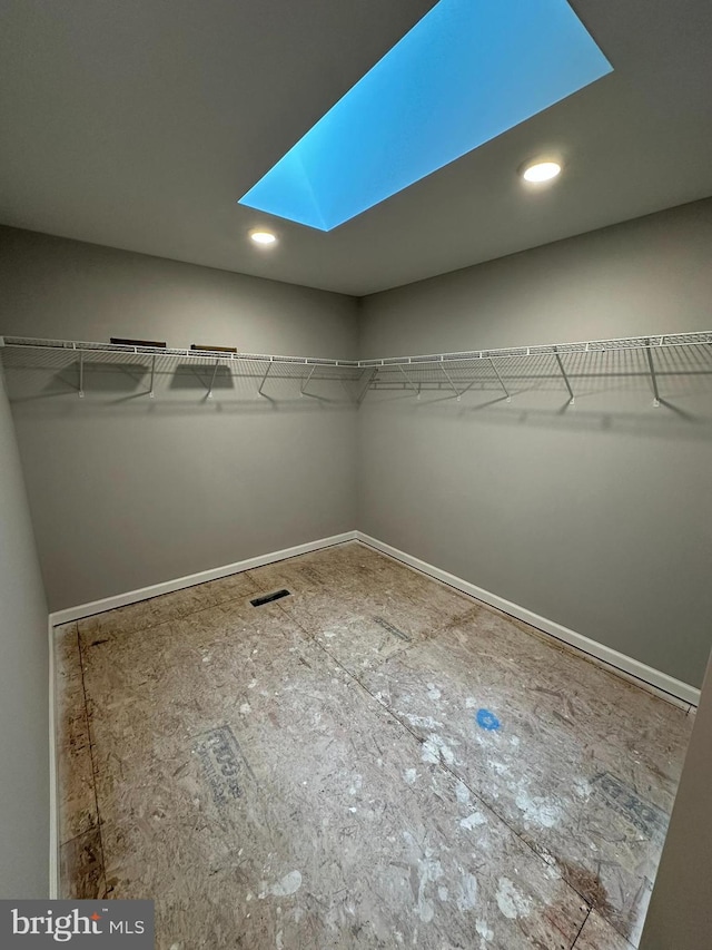 spacious closet featuring a skylight