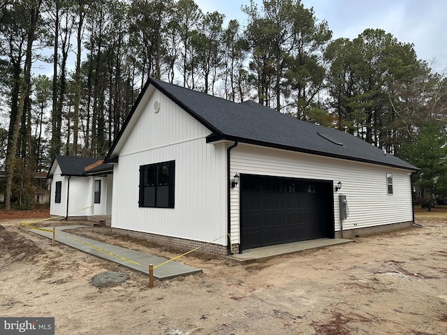 view of side of home with a garage