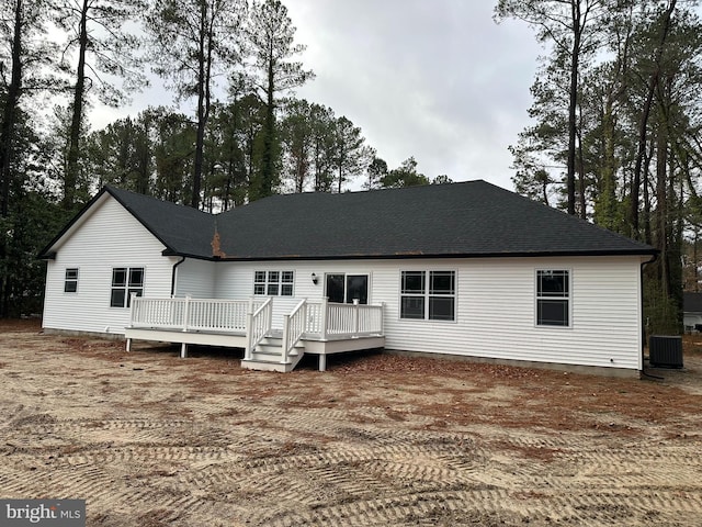 rear view of house with central air condition unit and a deck