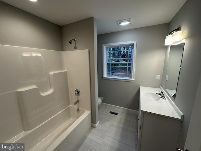 full bathroom featuring shower / bathing tub combination, vanity, and toilet