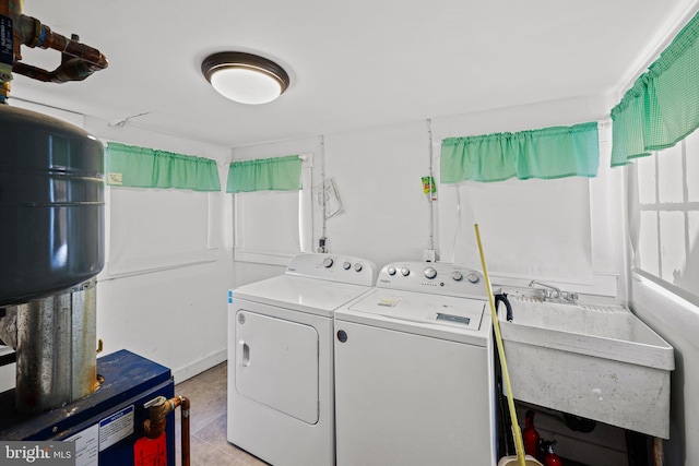 clothes washing area with sink and washer and dryer