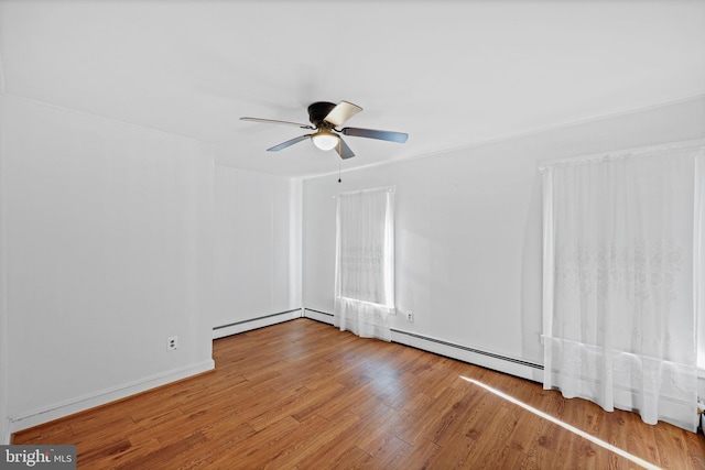 unfurnished room featuring baseboard heating, ceiling fan, and hardwood / wood-style floors