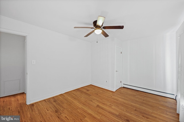 empty room featuring ceiling fan, light wood-type flooring, and baseboard heating