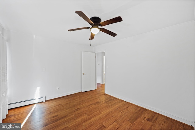 unfurnished room featuring ceiling fan, wood-type flooring, and a baseboard radiator