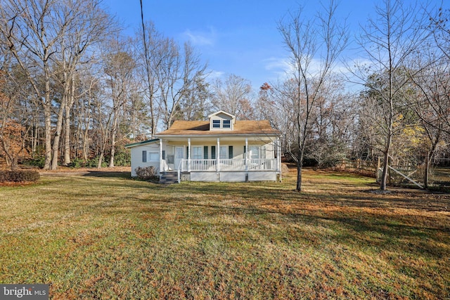 view of front of house featuring covered porch and a front yard