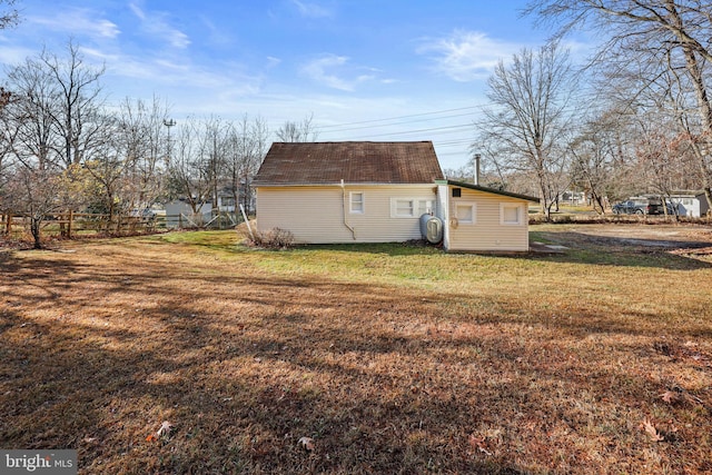 view of side of home featuring a lawn