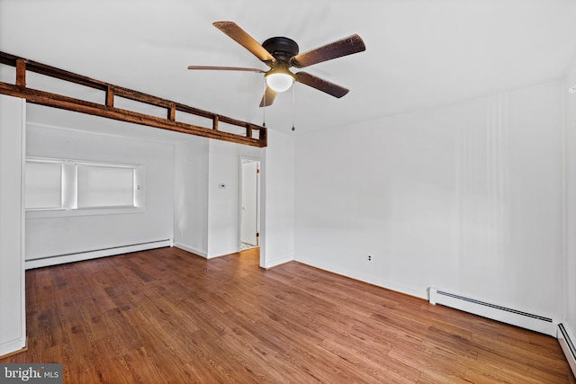 empty room with ceiling fan, a baseboard radiator, and hardwood / wood-style flooring