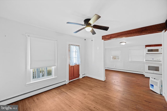 unfurnished living room with a baseboard radiator, a wealth of natural light, and hardwood / wood-style flooring