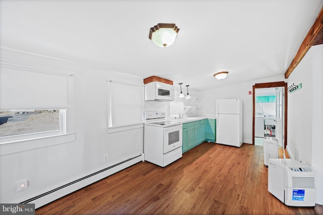 kitchen featuring white appliances, a baseboard heating unit, sink, vaulted ceiling, and light hardwood / wood-style flooring