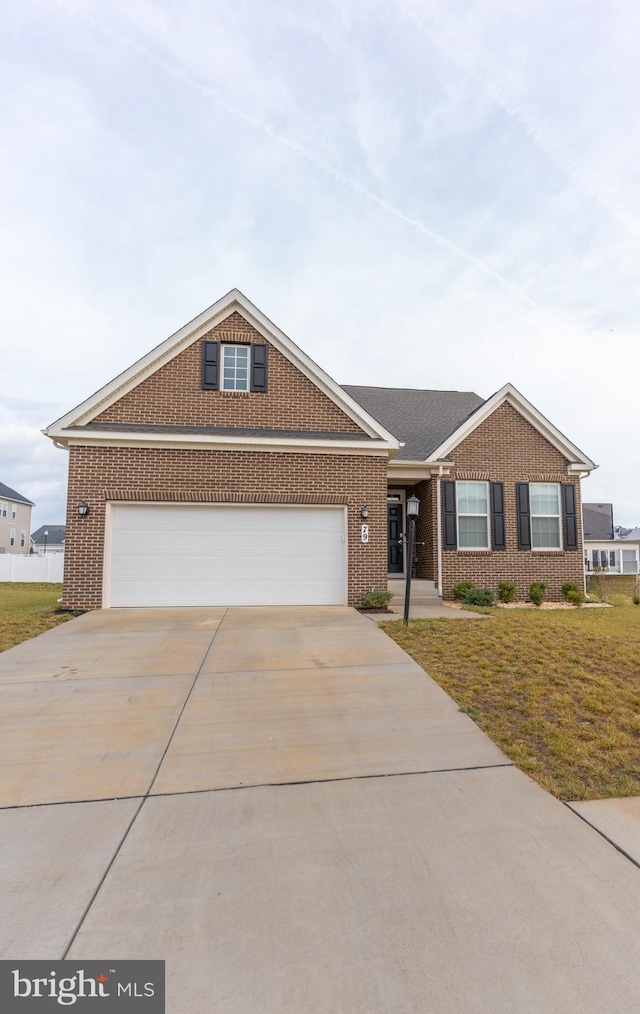 ranch-style house featuring a garage and a front lawn