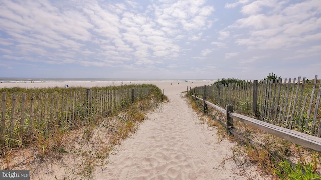 view of road with a water view and a view of the beach