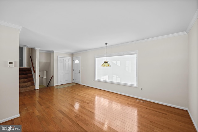 interior space with hardwood / wood-style floors and ornamental molding