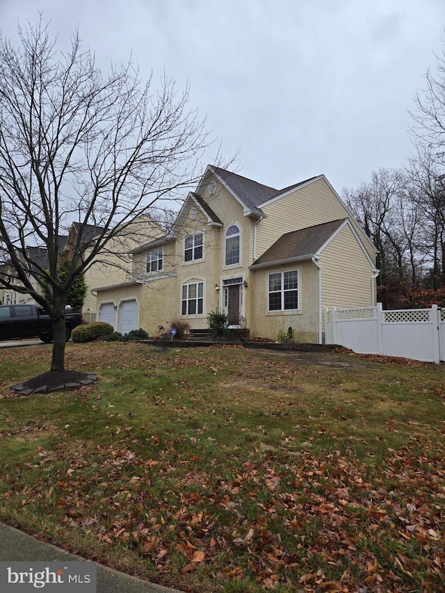 view of front of property with a front yard and a garage