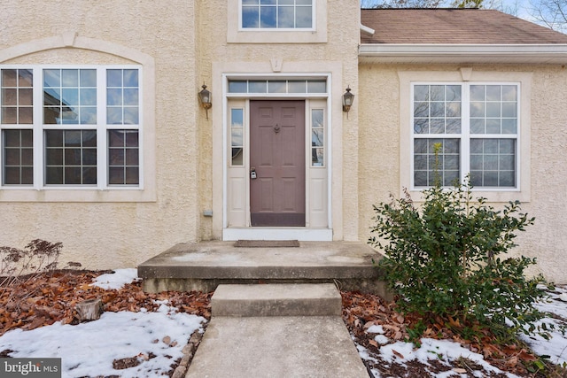 view of snow covered property entrance