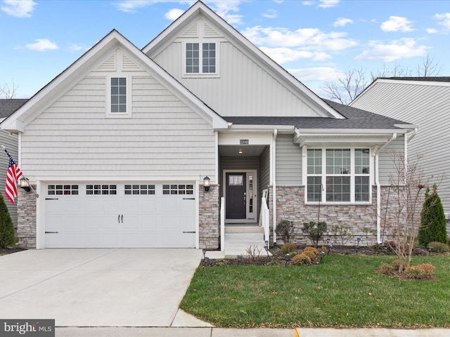 view of front of property with a garage and a front lawn