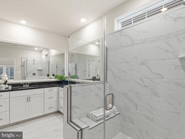 bathroom featuring vanity and a shower with shower door