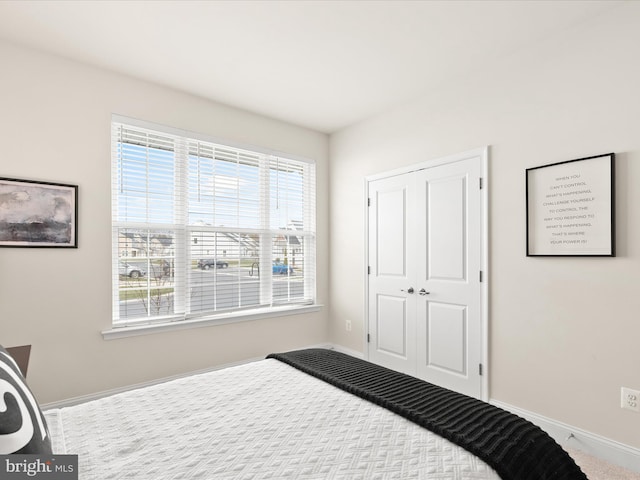 carpeted bedroom featuring a closet