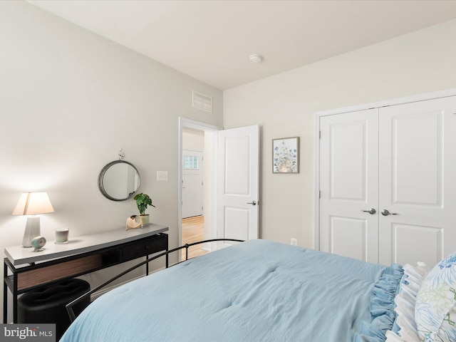 bedroom with wood-type flooring and a closet