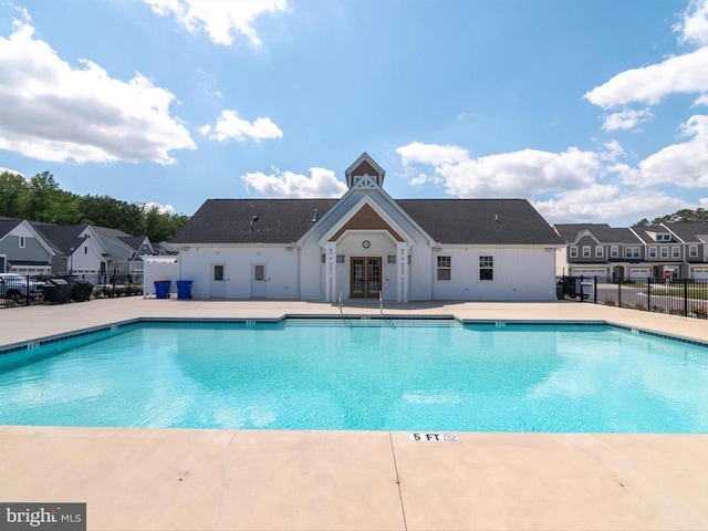 view of pool with french doors