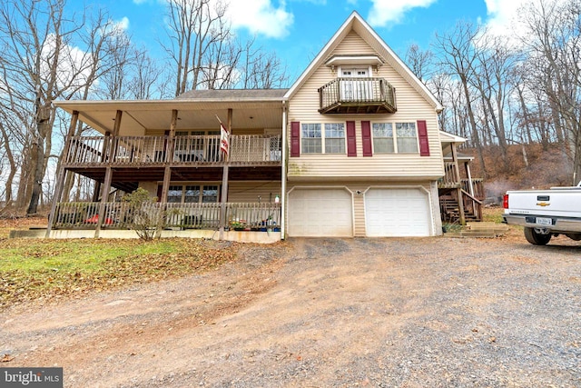 view of front of property with a garage and a balcony