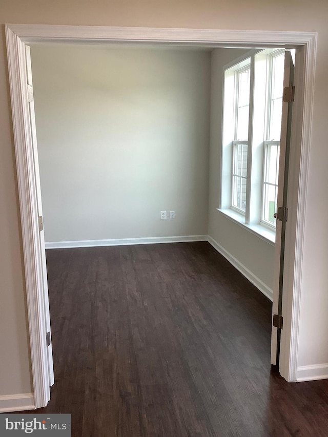 unfurnished room featuring dark hardwood / wood-style floors